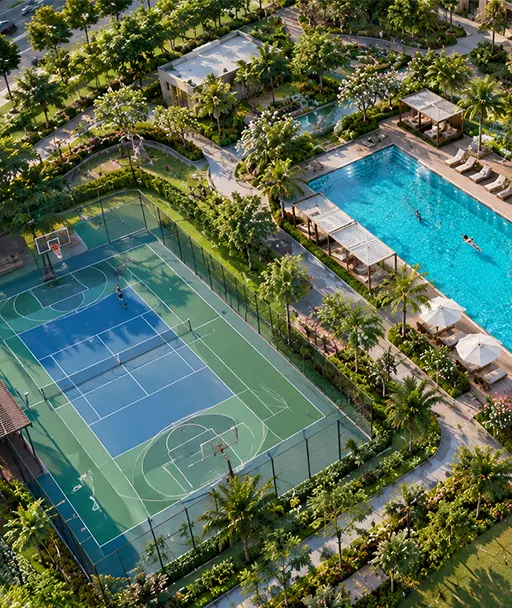 Aerial view of a swimming pool, a sports court and landscaped gardens